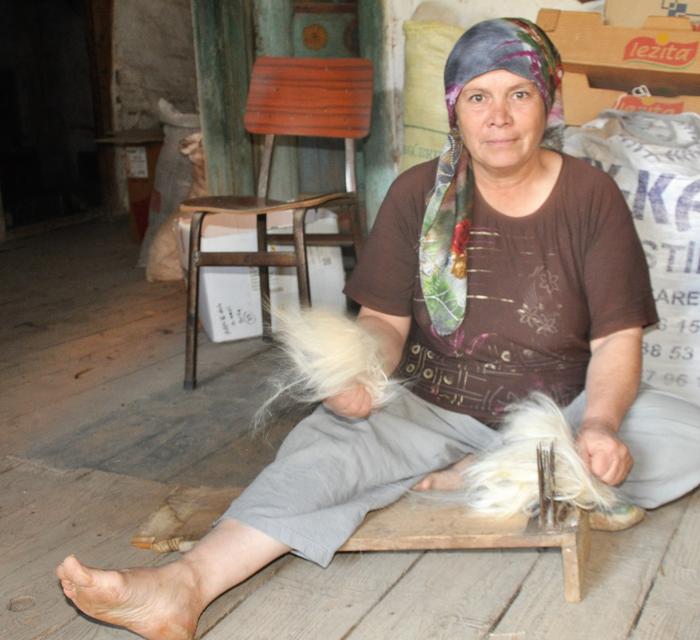 An Anatolian Turkmen lady combing goat hair to make nomadic tent Olukbaşı Village, Bozgoğan, Aydın City, Western Turkey 2016