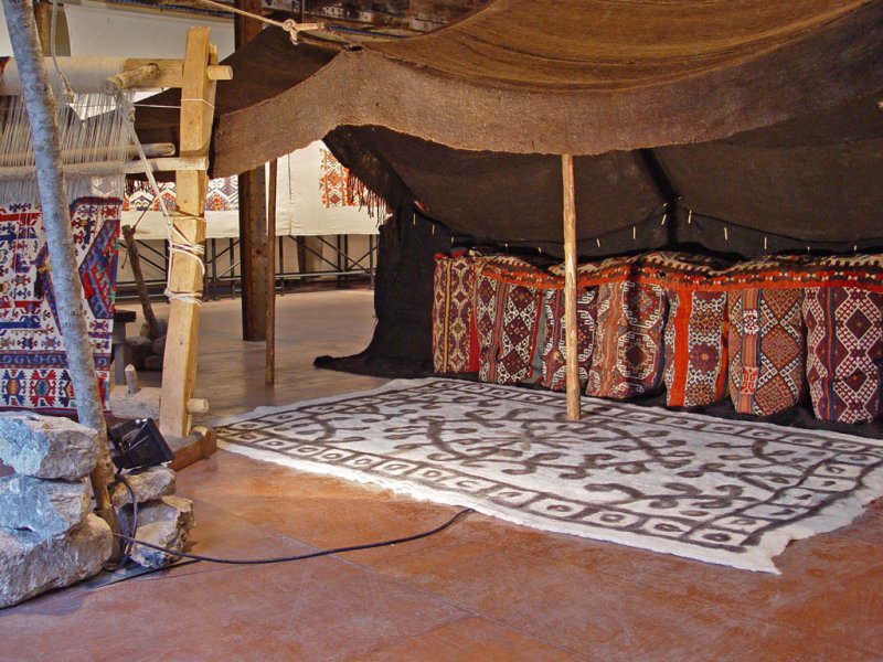Personal clothing sacks put in the black tent, forming a platform to sit in front. Josephine Powell exhibition, Koç Foundation, 2006