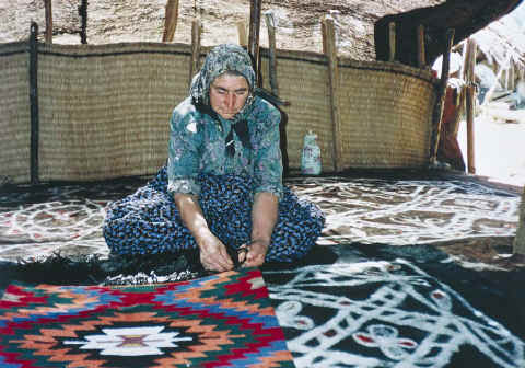 An Anatolian Turkmen woman from Karakoyunlu tribe seen sitting on the felt rugs she made in the black tent. Anamas Pasture, Beyşehir, Konya, 1980s